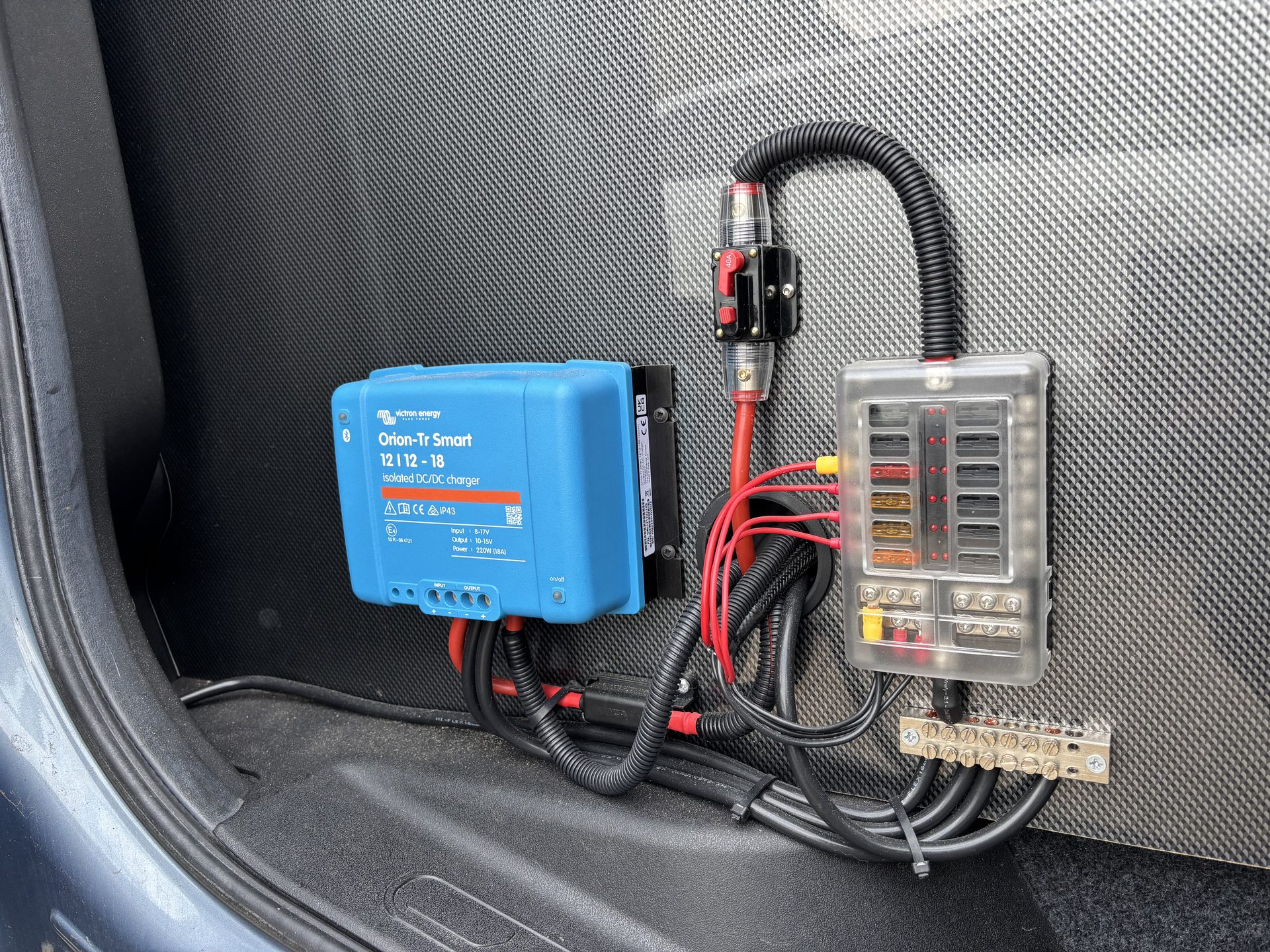 Victron DC-DC charger and fuse box neatly wired inside a campervan conversion
